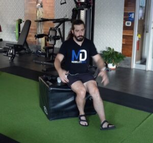 Dr. John doing a box squat to strengthen his knee